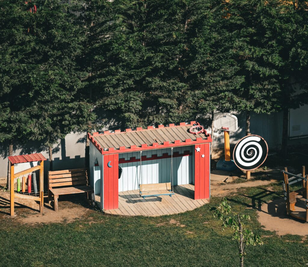 Aerial view of a sunlit playground with swings and vibrant structures in Istanbul, Turkey.